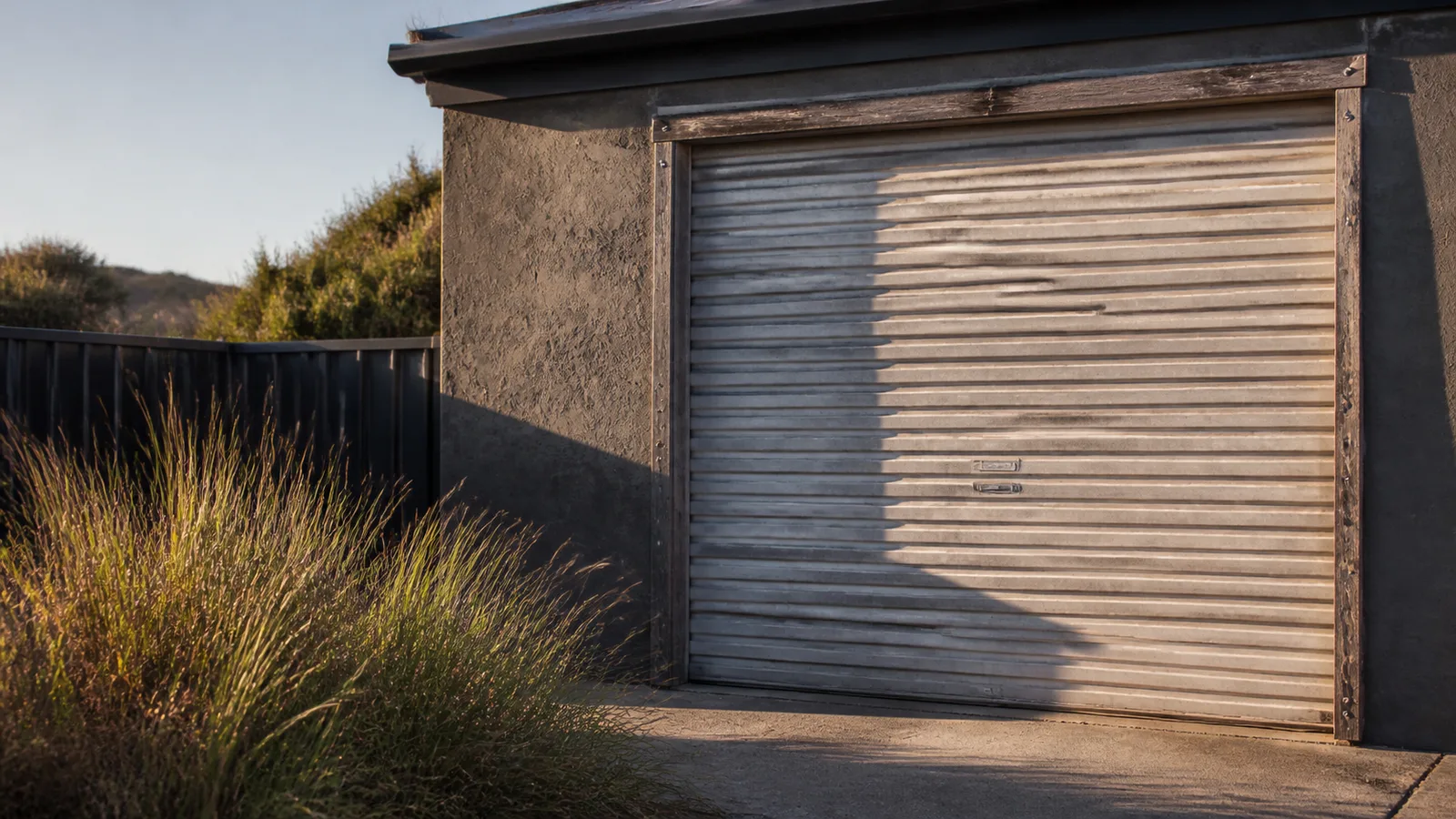 Salt-corroded fixings and sun-faded roller door on a west-facing Perth coastal home